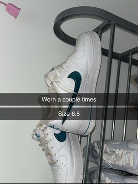 White Nike Air Force’s with blue holographic Nike Swoosh